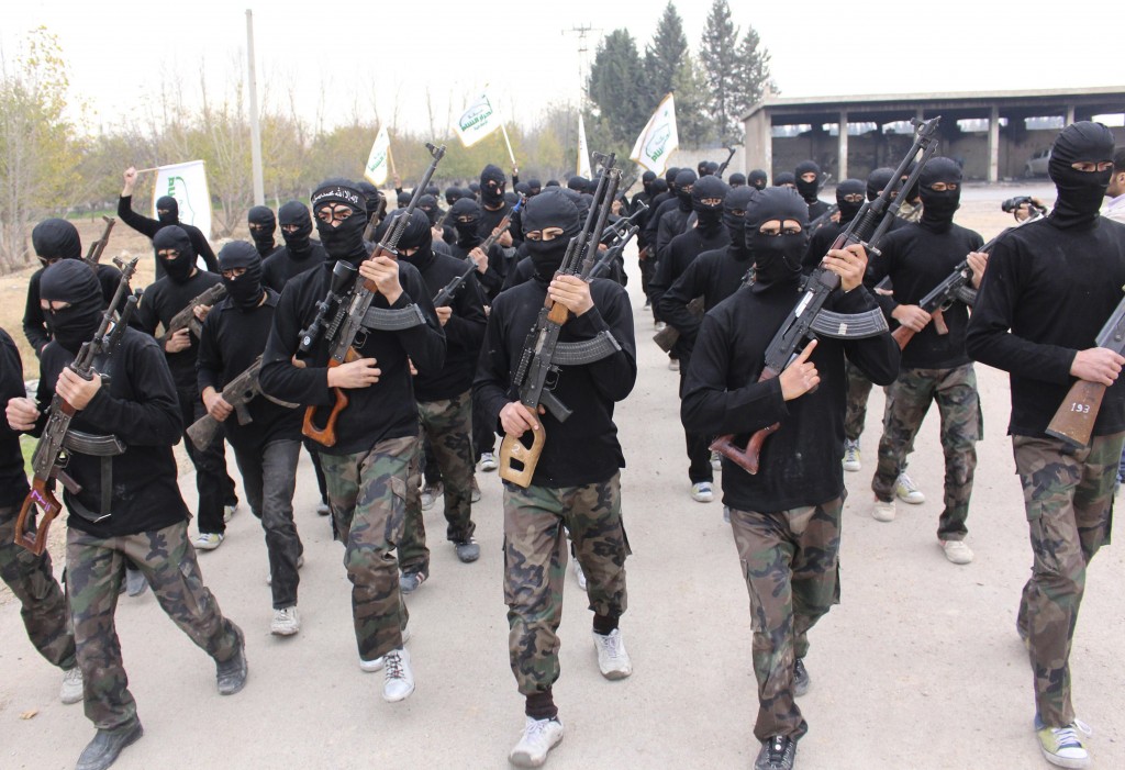 Islamist fighters carry weapons as they march during their graduation ceremony at a camp in eastern al-Ghouta, near Damascus N