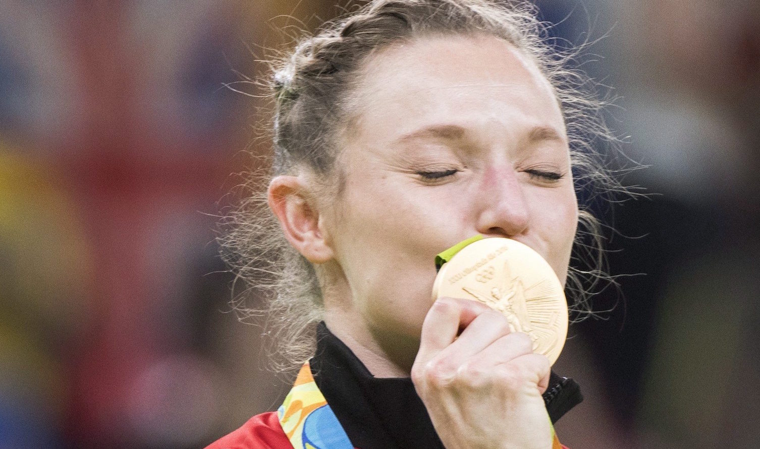 Canada's Rosie MacLennan, from King City, Ont., kisses her gold medal after winning the trampoline gymnastics competition at the 2016 Summer Olympics Friday, August 12, 2016 in Rio de Janeiro, Brazil.THE CANADIAN PRESS/Ryan Remiorz