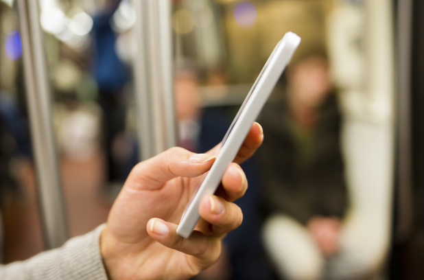 Woman using her Smart phone in Subway