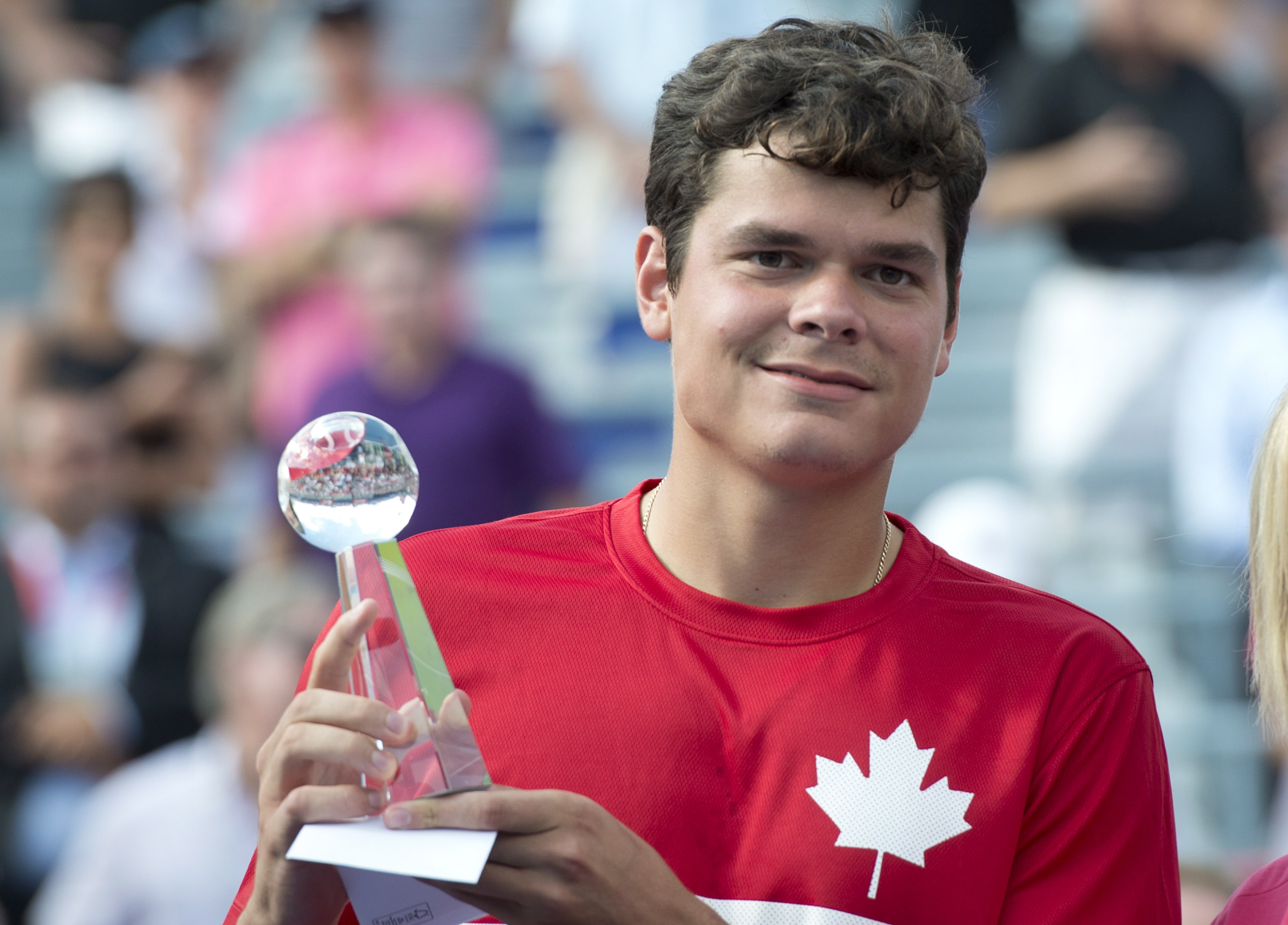 Canada's Milos Raonic holds his runners-up trophy after losing to Rafael Nadal from Spain during the final at the Rogers Cup tennis tournament Sunday August 11, 2013 in Montreal. THE CANADIAN PRESS/Paul Chiasson