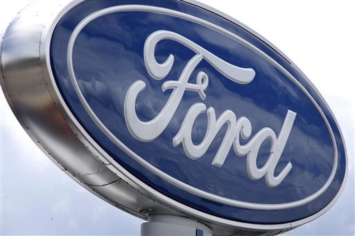FILE - In this Thursday, June 5, 2014, file photo, clouds are reflected in the Ford sign at a dealership in Wexford, Pa. Ford on Wednesday, Sept. 30, 2015 said it is recalling some older Windstar minivans to because a previous rear-axle recall repair might not work. (AP Photo/Keith Srakocic, File)